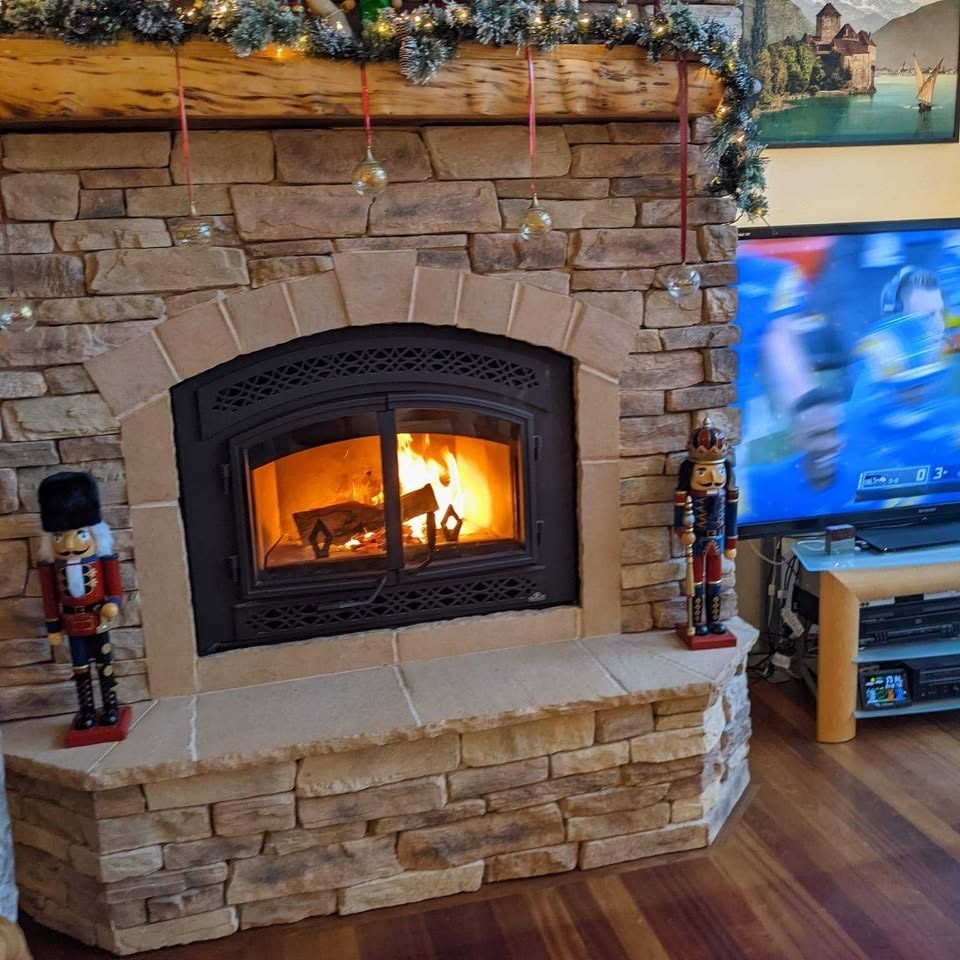 Stone fireplace with a lit fire and decorative mantel