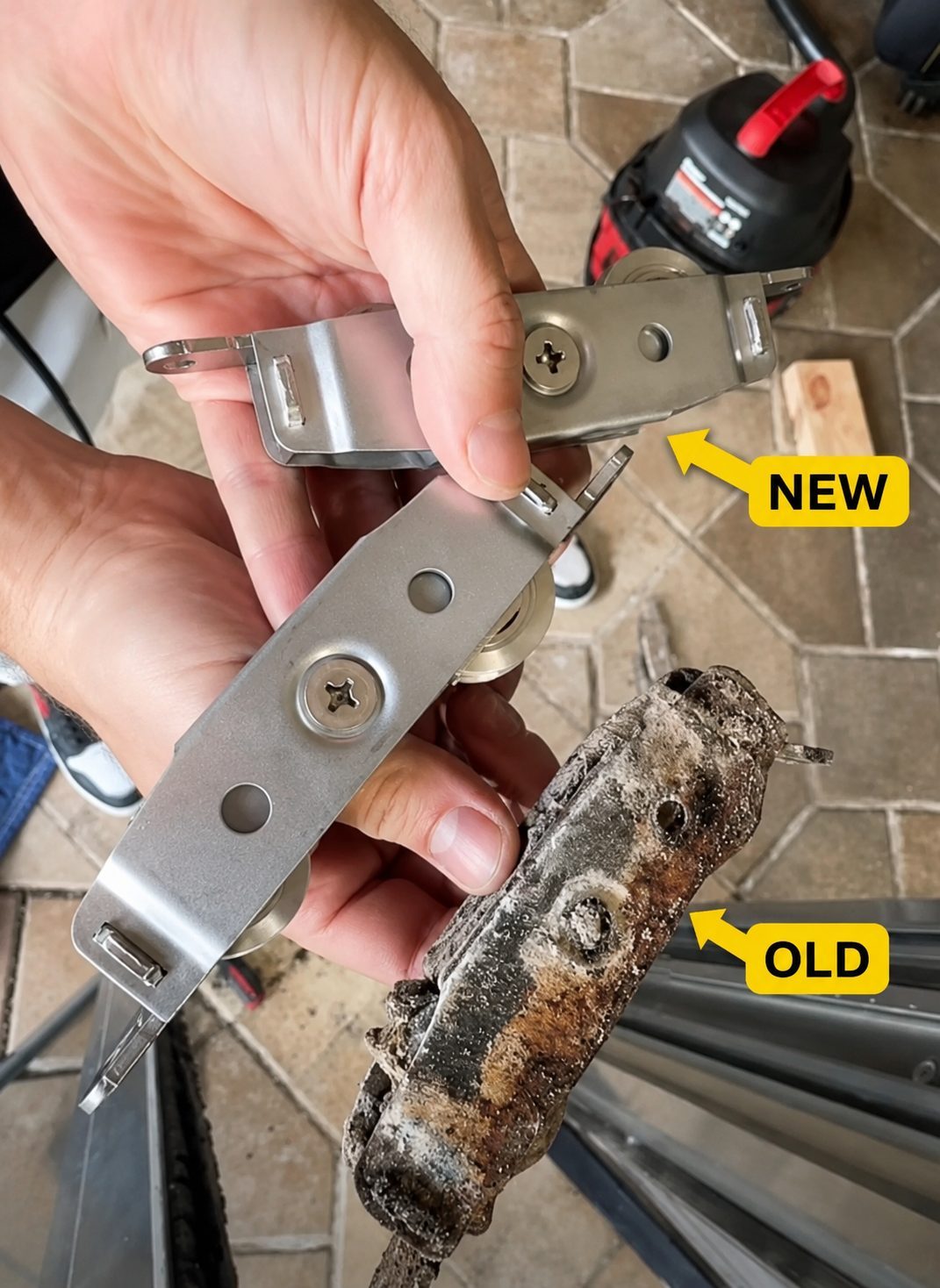 Old and new sliding door rollers held side by side during a replacement