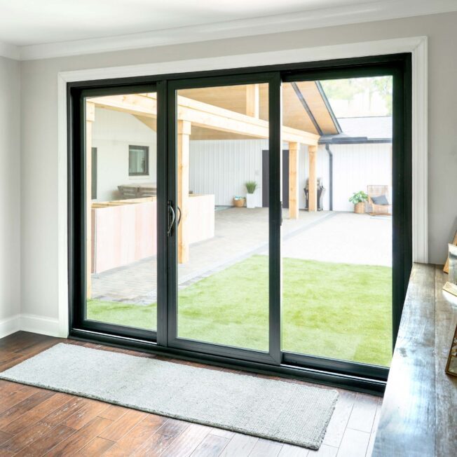 Black-framed sliding glass door installed in a modern home
