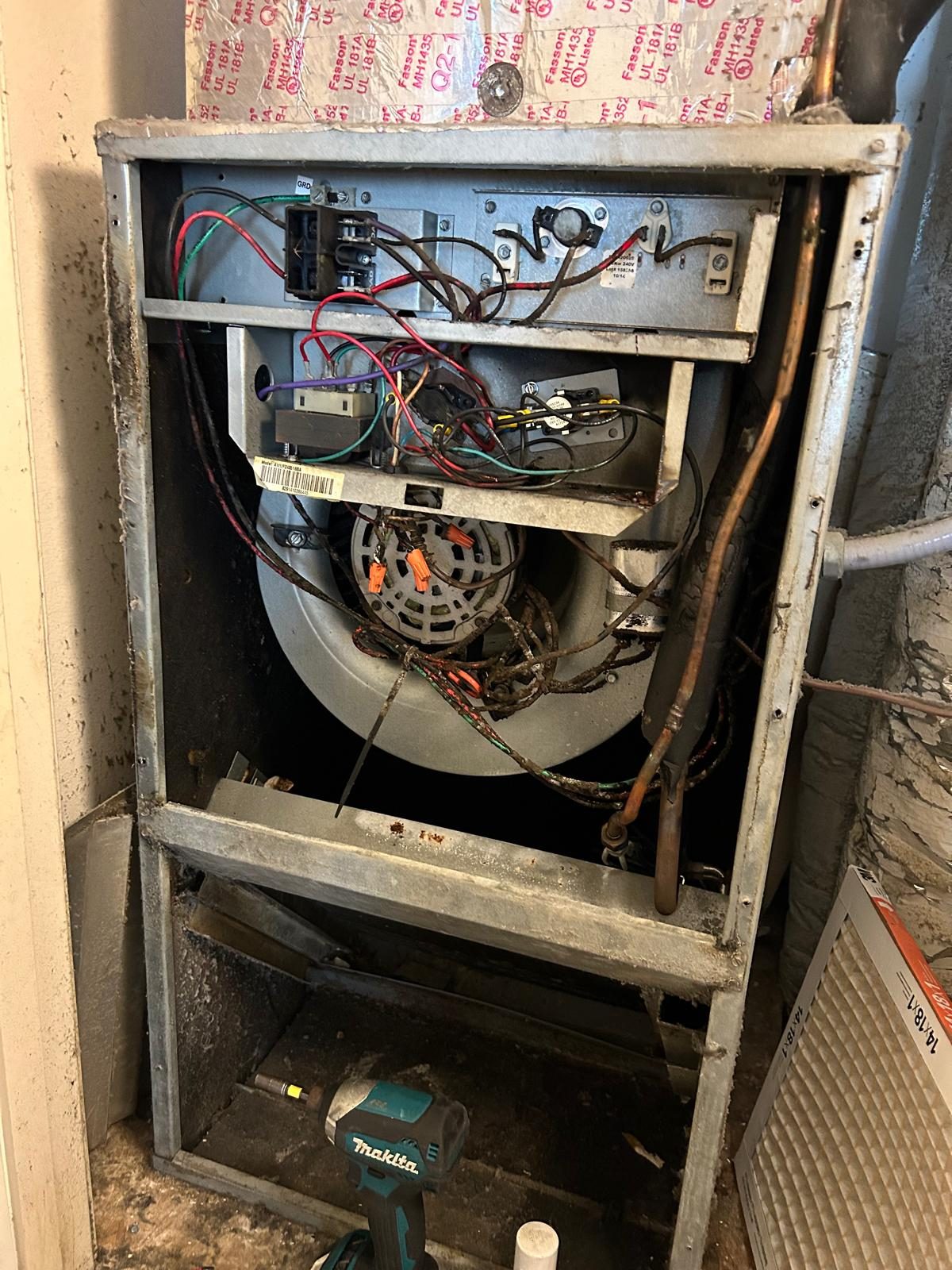 HVAC air handler interior with blower and filter during cleaning