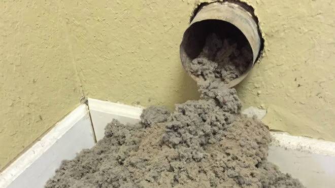 Dryer vent clogged with lint being cleared